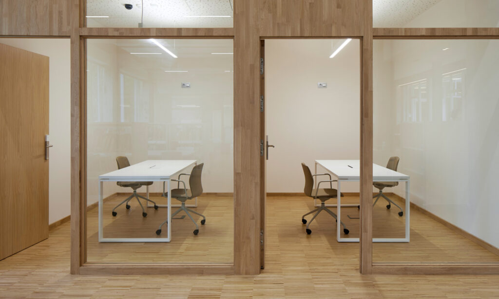 Source International new chair behind glass in office space
