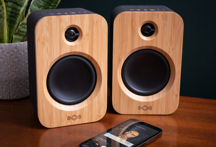 Get Together Duo speakers on table with phone containing image of Bob Marley