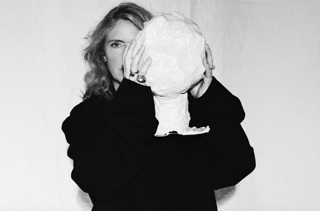 Image of the designer holding a paper maché object