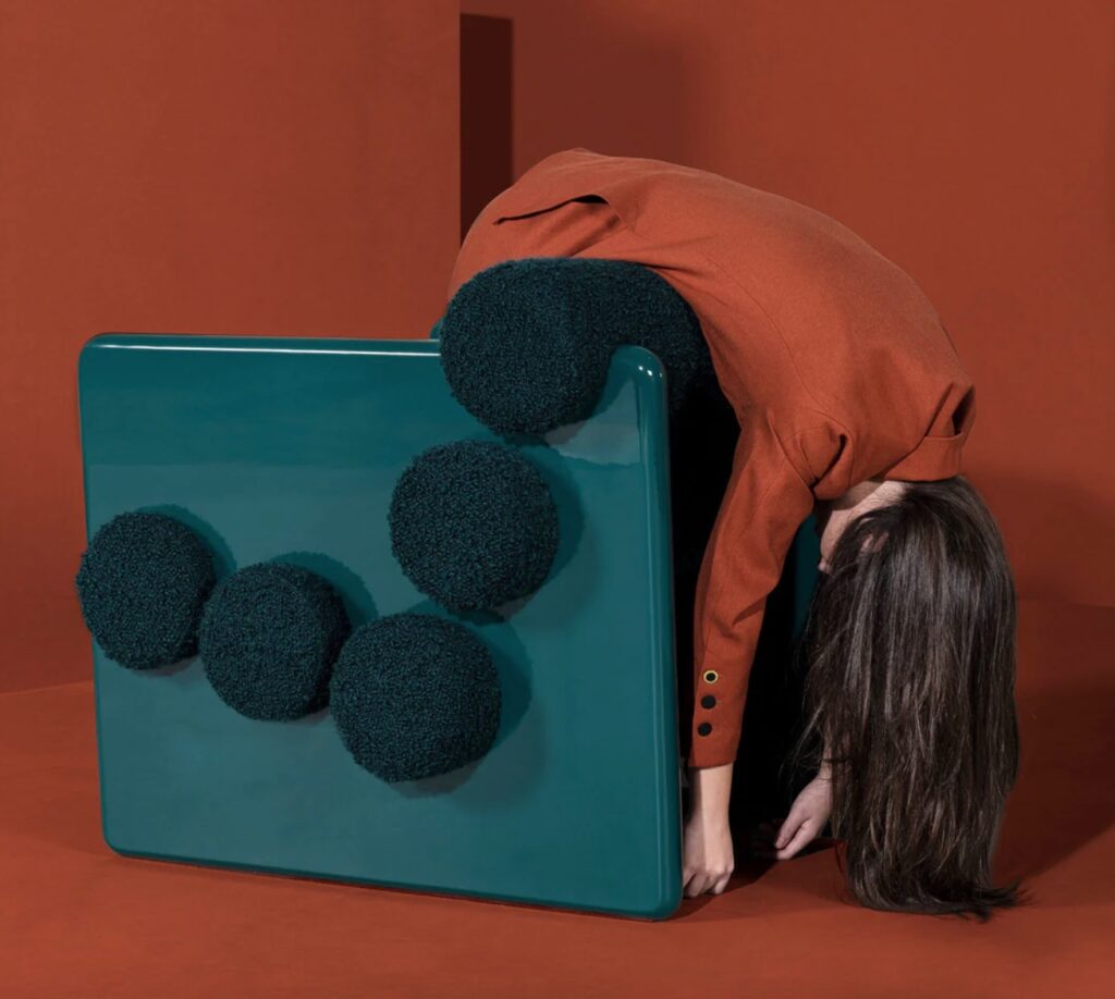 Woman draped over the back of Royal Stranger chair