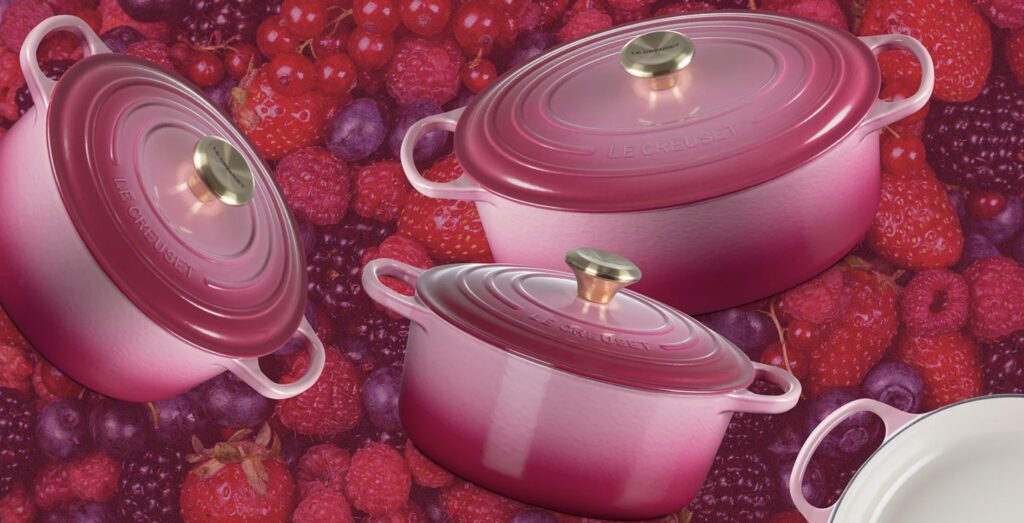 Le Creuset Signature Round Dutch Oven in Berry among a berry background