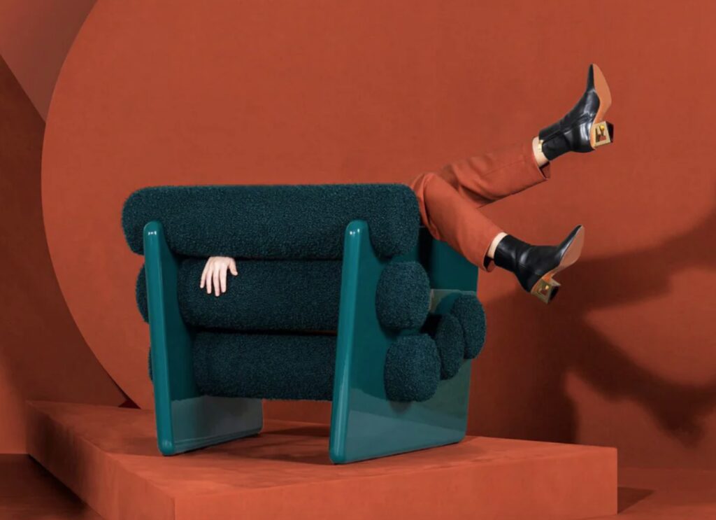 Whimsical armchair with hand and legs of woman visible 