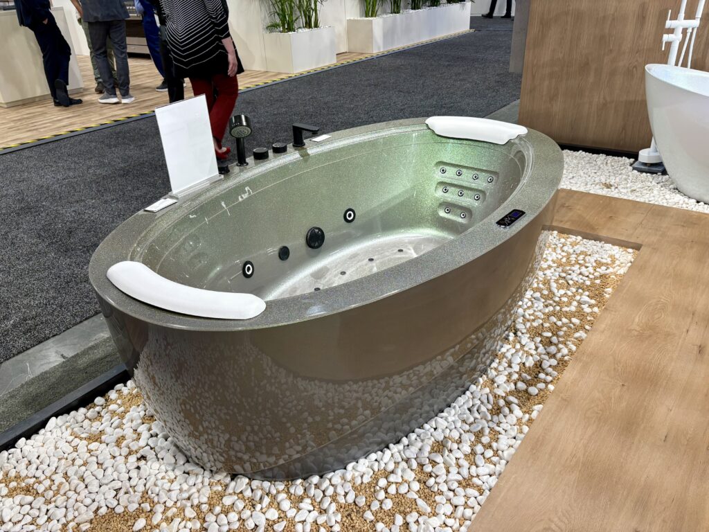 Iridescent silver oval-shaped bathtub at KBIS 2025