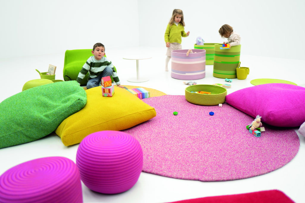 Soft seating, baskets, pillows, and large rug from children's furniture collection