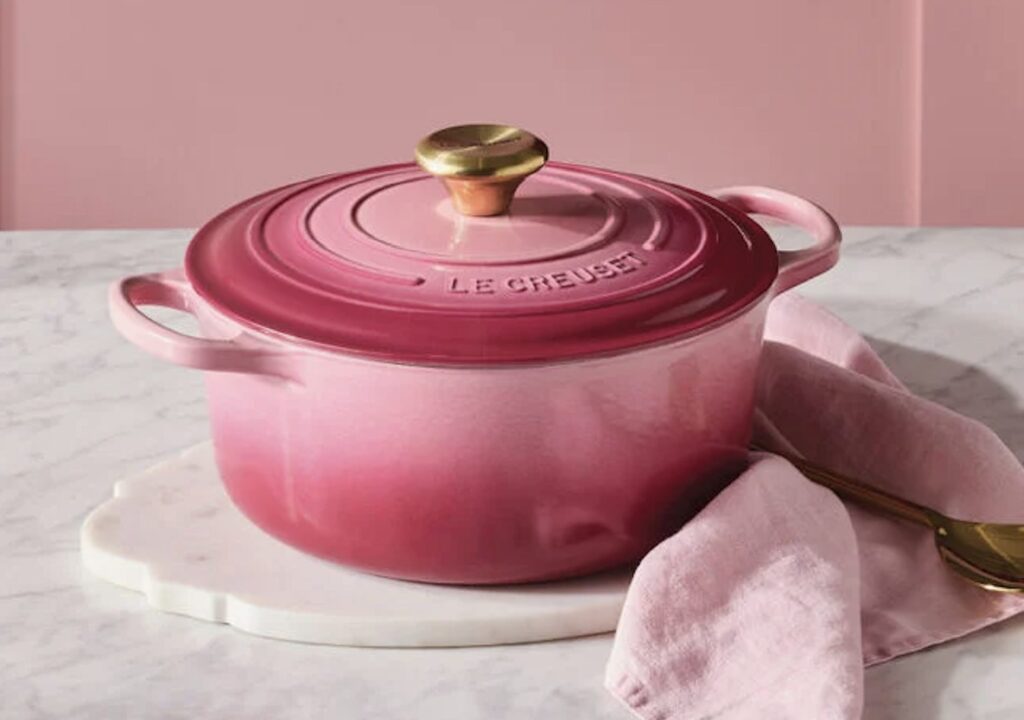 Le Creuset Signature Round Dutch Oven in Berry on a marble countertop with a pink linen napkin