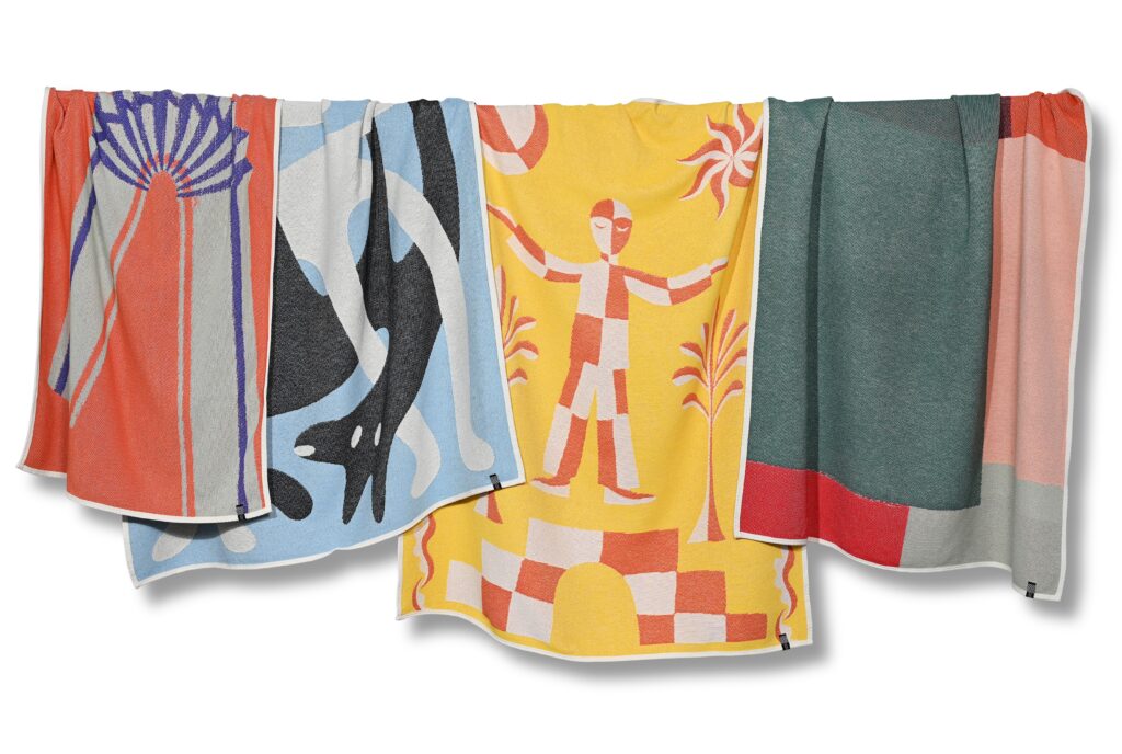 Four blankets hanging on line