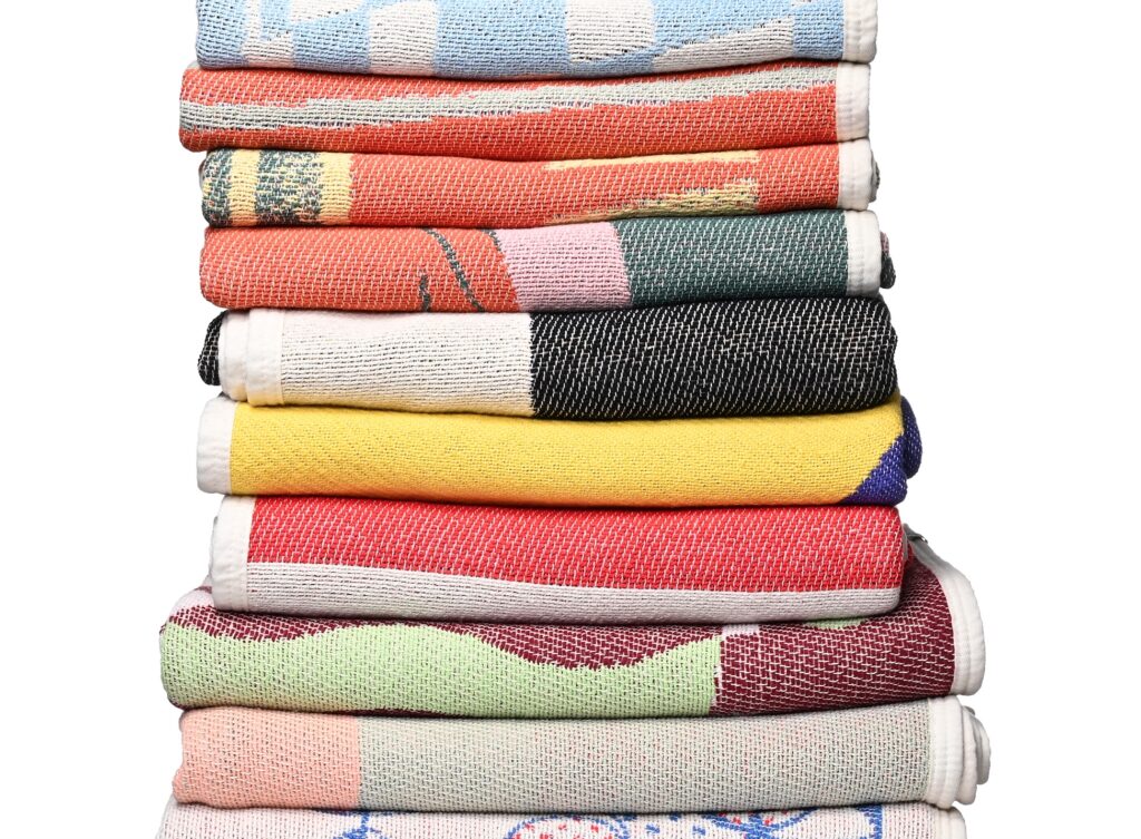 Large stack of folded blankets from ZigZagZurich