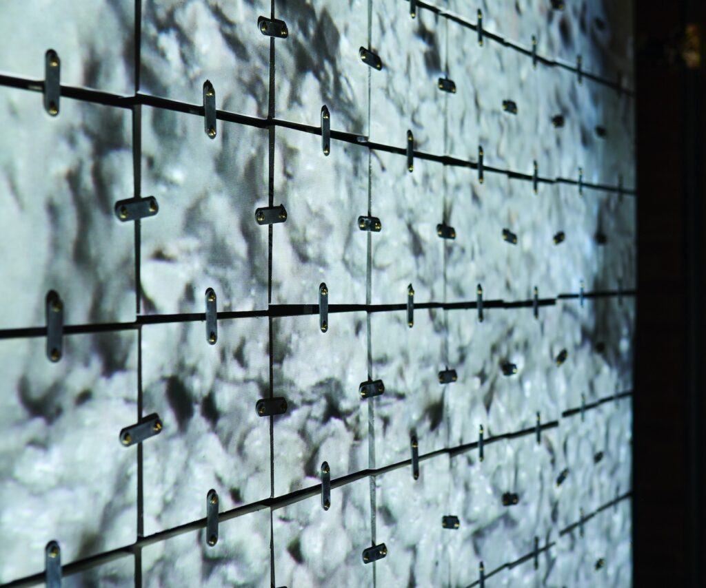 Tiles joined by metal fasteners at Concreta exhibit