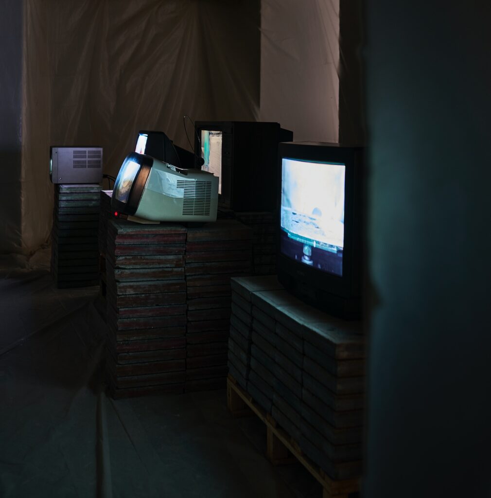 Concreta room 3 with TVs resting on stacked tiles