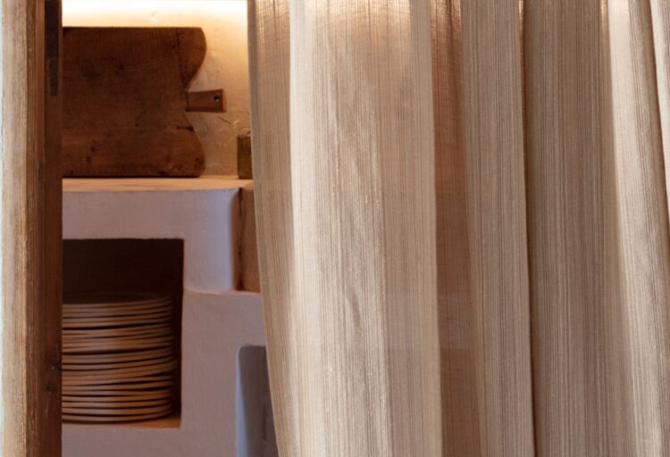 Timeless Traces textile in front of kitchen storage with classic stoneware