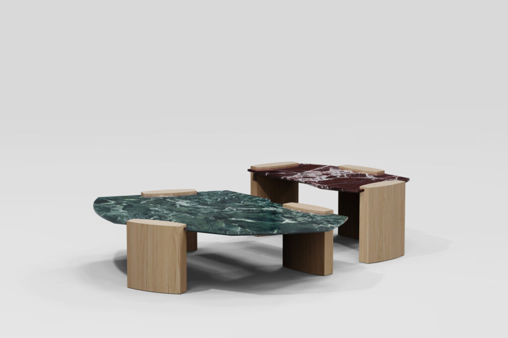 Two Kora Coffee Tables with green and burgundy marble tops balanced on pale wood legs—offset geometry giving each coffee table a sense of movement and tension.