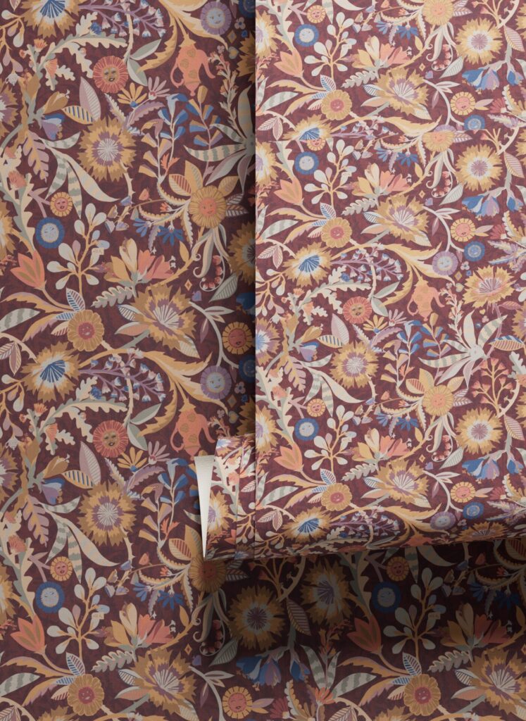 Close-up of richly patterned floral wallcovering in ochre, rose, and indigo tones, where layered botanical motifs bring romantic energy to modern hospitality color trends.