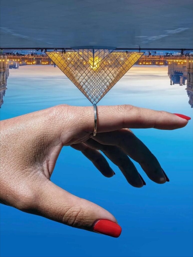 A sliced mango is held beside a yellow-and-blue rowboat, the fruit’s color and shape aligning so precisely that the mango could be mistaken for a cutaway section of the boat. A tropical, slightly absurd play on matching hues and forms.