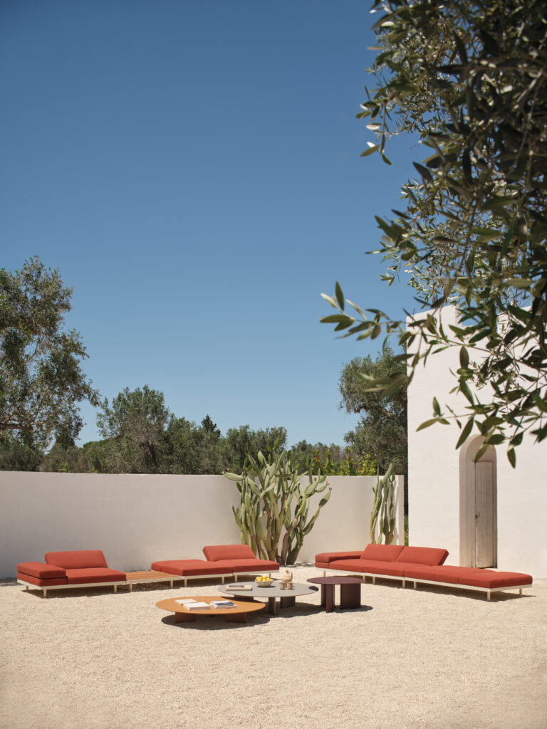 Island-style composition of Unduetre outdoor modular seating with low tables, demonstrating flexible layouts designed for shared, open-air living.