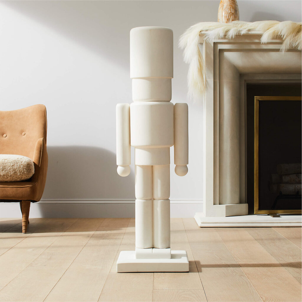A white cement toy soldier sculpture by CB2, delivering holiday decor with architectural restraint and a sculptural, modern edge.