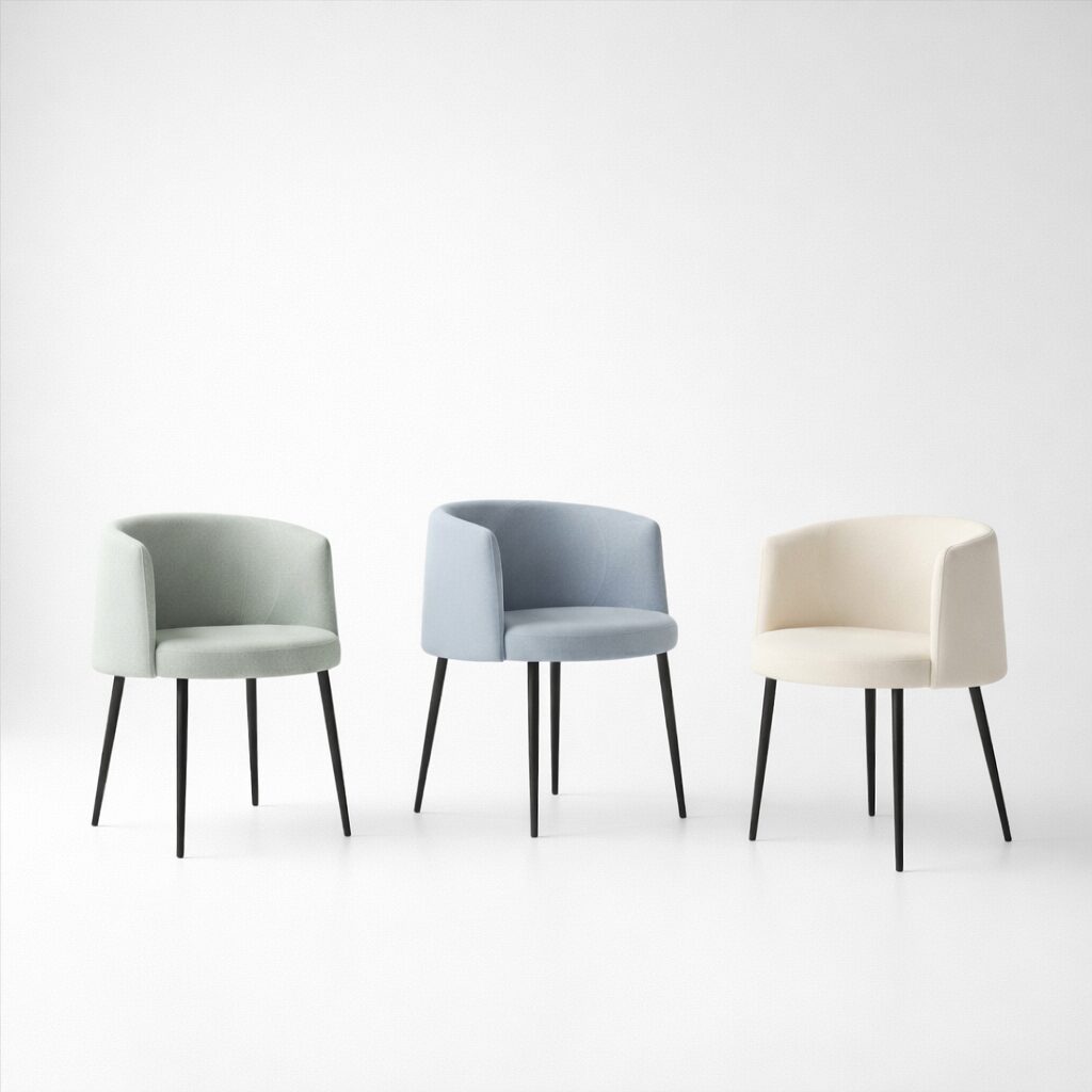 Upholstered dining chairs in muted green, blue, and cream, highlighting Sonic’s curved silhouette and calm, architectural scale.