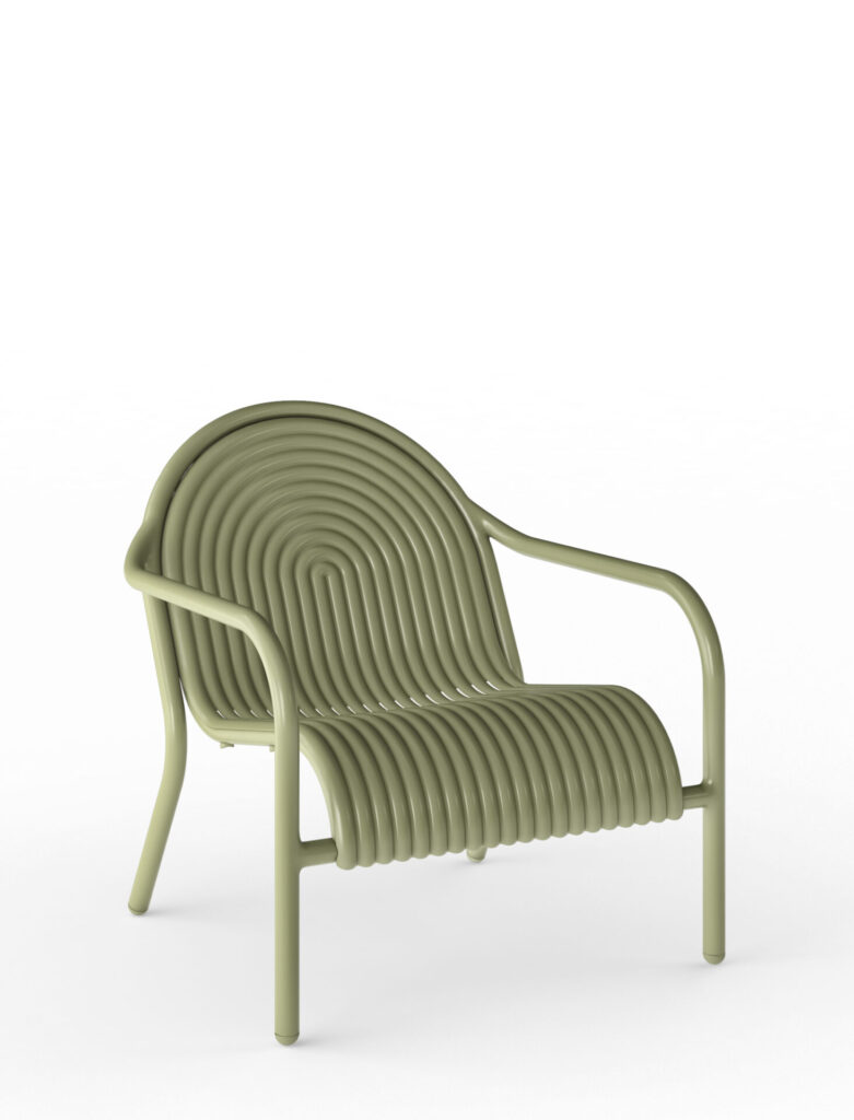 Tom Dixon Groove Lounge Chair shown on a white background, featuring concentric ribbed detailing, a sunken seat, and a high-gloss finish designed for commercial outdoor furniture.