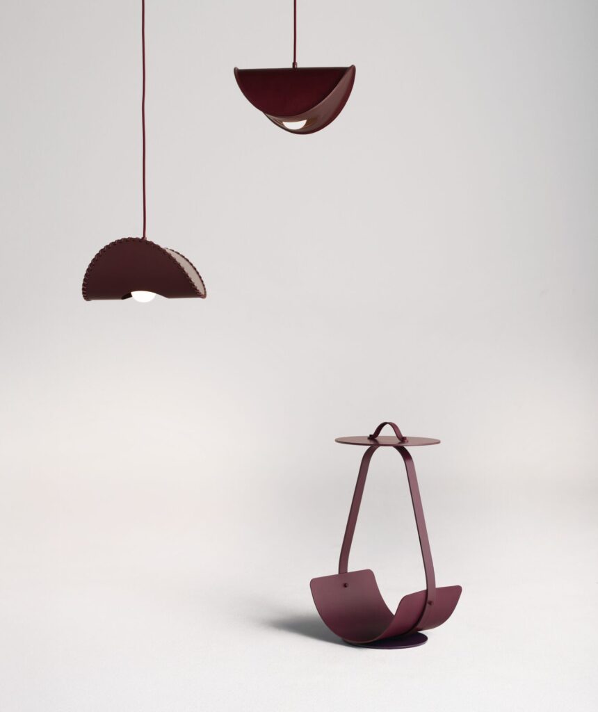 Borgona pendant lighting by Uniqka shown in a monochromatic installation at Maison&Objet 2026, where curved leather-like forms and stitched edges emphasize texture within a deep burgundy lighting design.