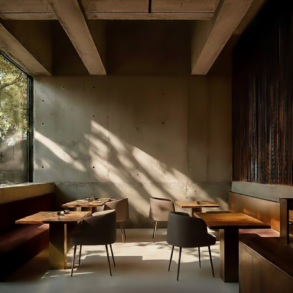 Upholstered dining chairs arranged in a warm café interior, showing how Sonic’s compact profile repeats cleanly around shared tables.