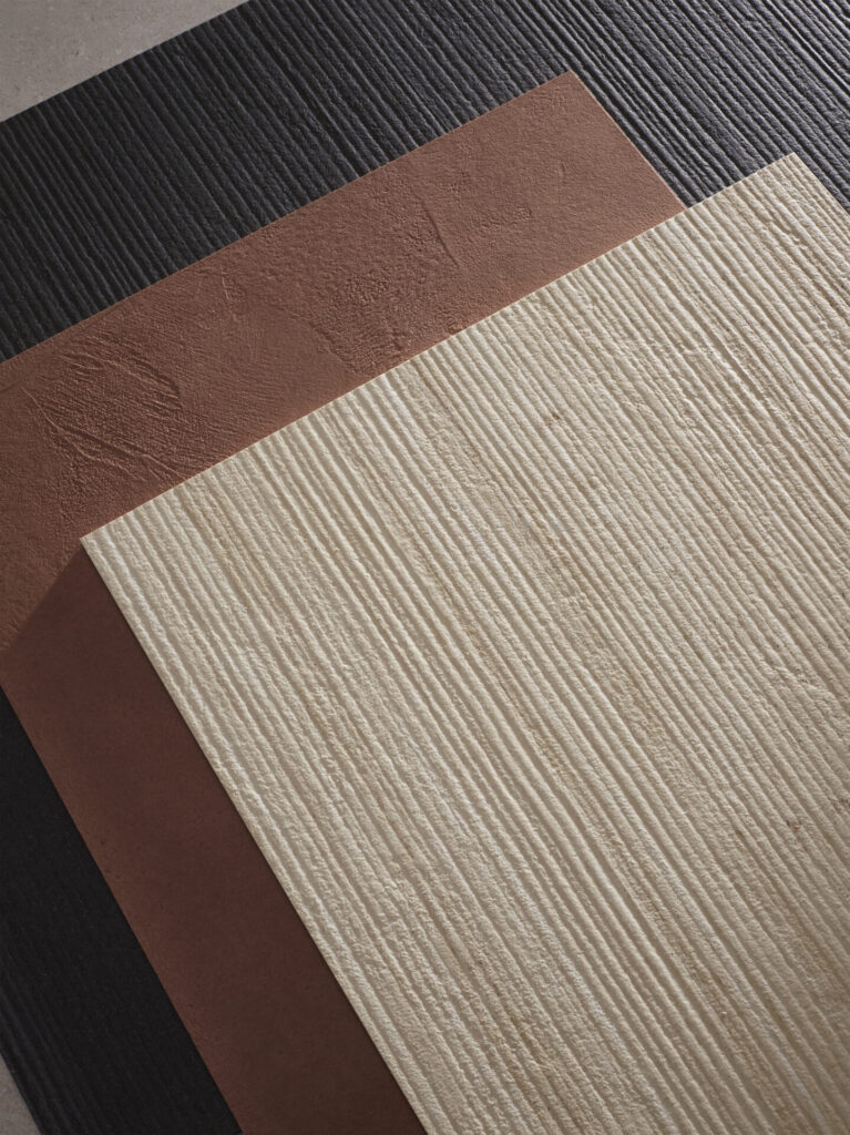 Layered Neolith ARCHITECTURAL large-format panels in Obsidian, Azahar, and Serpeggiante tones, showcasing Rigato striations and matte finishes designed for interior wall cladding and ventilated façade systems.