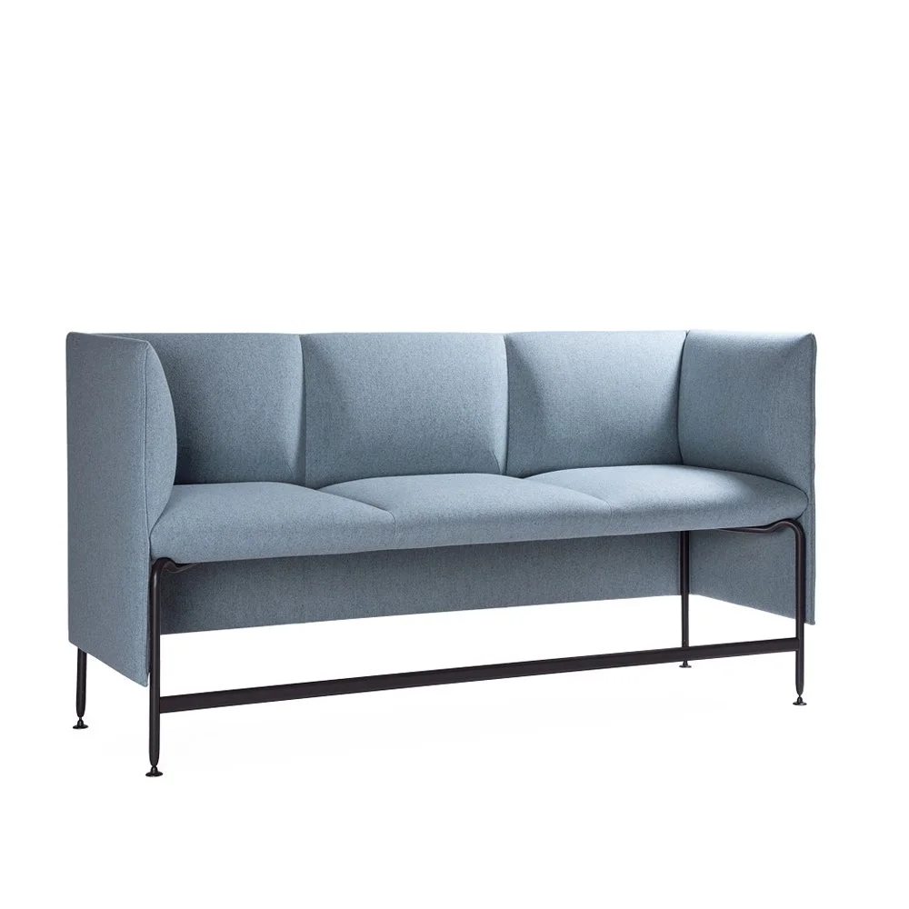 Three-seat modular lounge seating in muted blue with continuous wraparound back and refined steel base