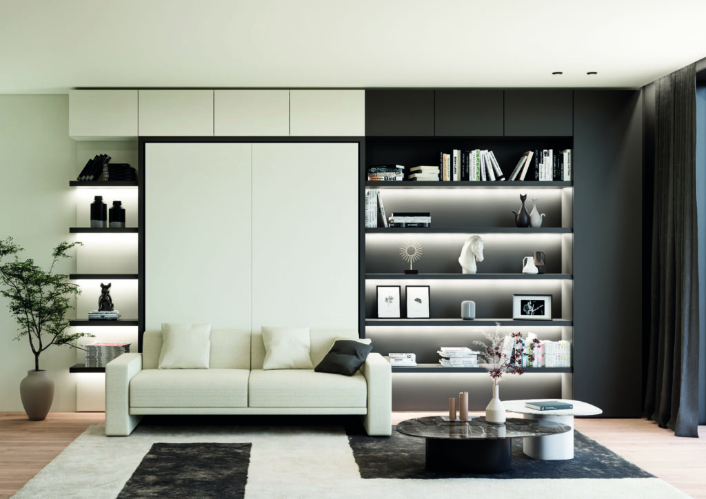 Built-in sofa wall bed system with integrated shelving and lighting transforms a living room into a bedroom, showcasing multifunctional furniture that blends seamlessly into millwork.