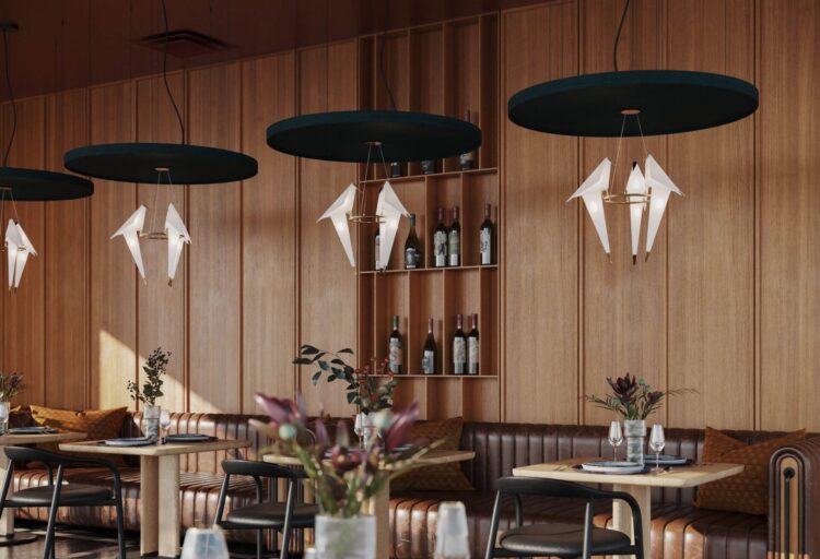 Dining space featuring multiple acoustic ceiling panels paired with origami-like pendant fixtures, illustrating integrated ceiling design.