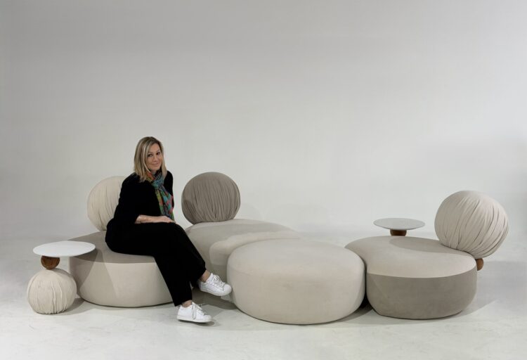Modular lounge seating by Anna Maya featuring rounded, pebble-like upholstered forms with pleated spherical backrests, shown in a flexible clustered arrangement