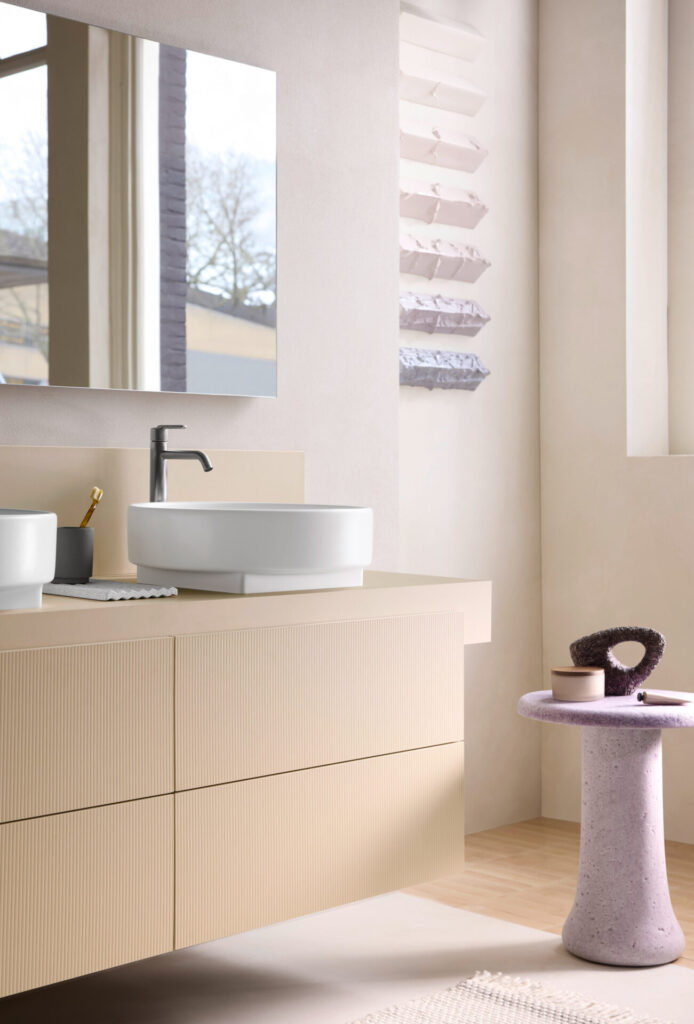 Floating Duravit Balcoon vanity with fluted fronts, vessel sinks, and pastel accents in a refined architectural bathroom design.