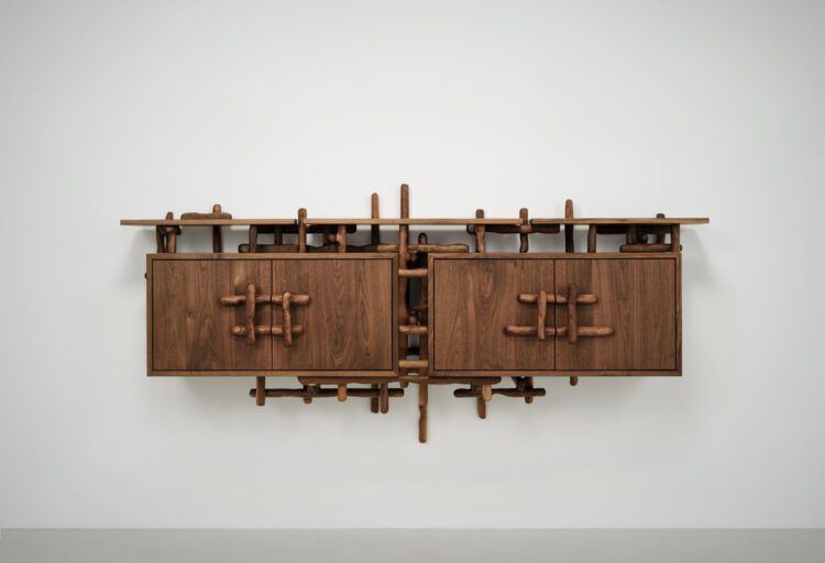 Walnut credenza from the Hedera collection by Onno Adriaanse for Dilmos, with branch-like carved wood detailing wrapping around clean cabinet volumes.