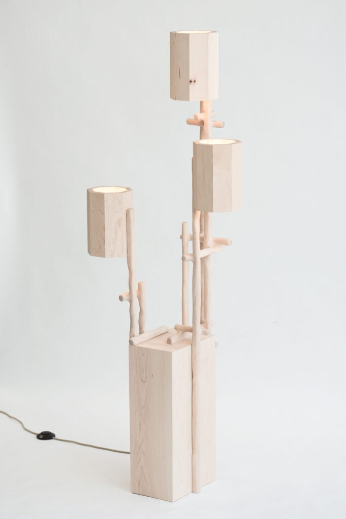 Sculptural maple floor lamp from Dilmos’ Hedera collection, with stacked geometric shades rising from hand-carved wooden stems.