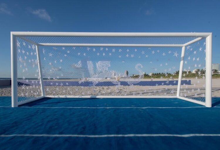 A monumental soccer goal on Miami Beach features handwoven constellations and mythical creatures across its net, transforming the field into a public art installation.