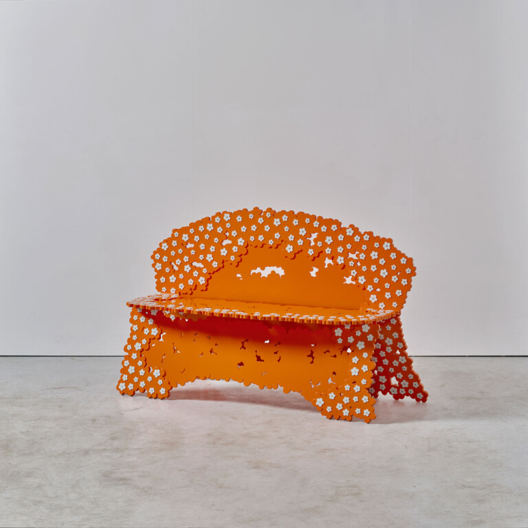 Arthur Vandergucht's orange floral-riveted settee combines handmade craftsmanship and playful designer furniture aesthetics.