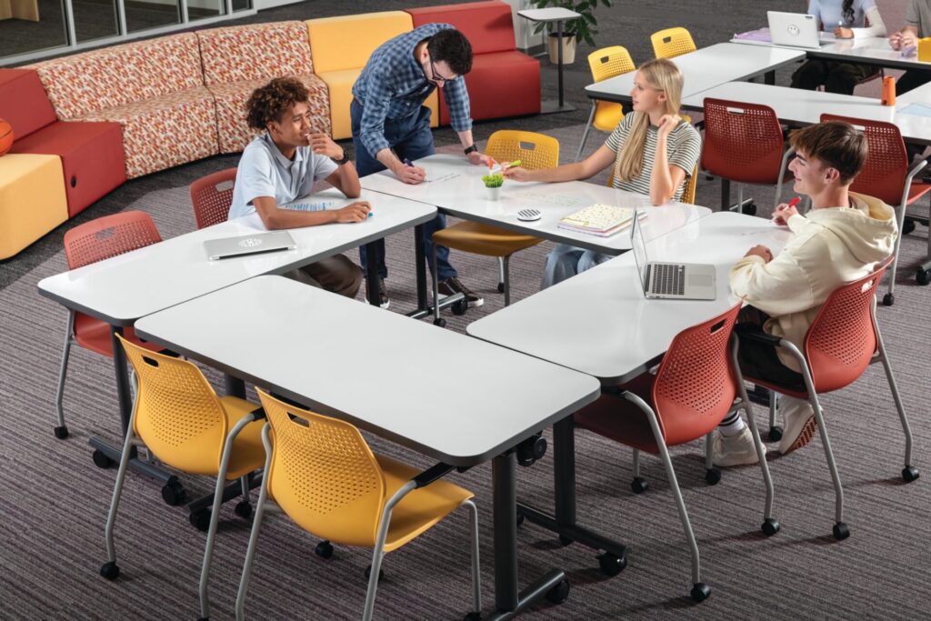 Students collaborate around reconfigurable Field Trip tables by HON, showcasing flexible classroom furniture for active learning environments.