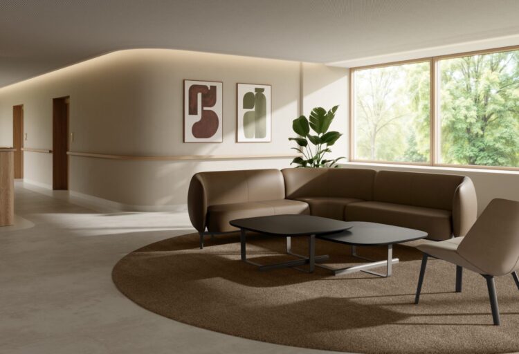 Modular sofa, lounge chair, and nested tables from the Etta commercial lounge seating collection furnish a warm healthcare waiting area.