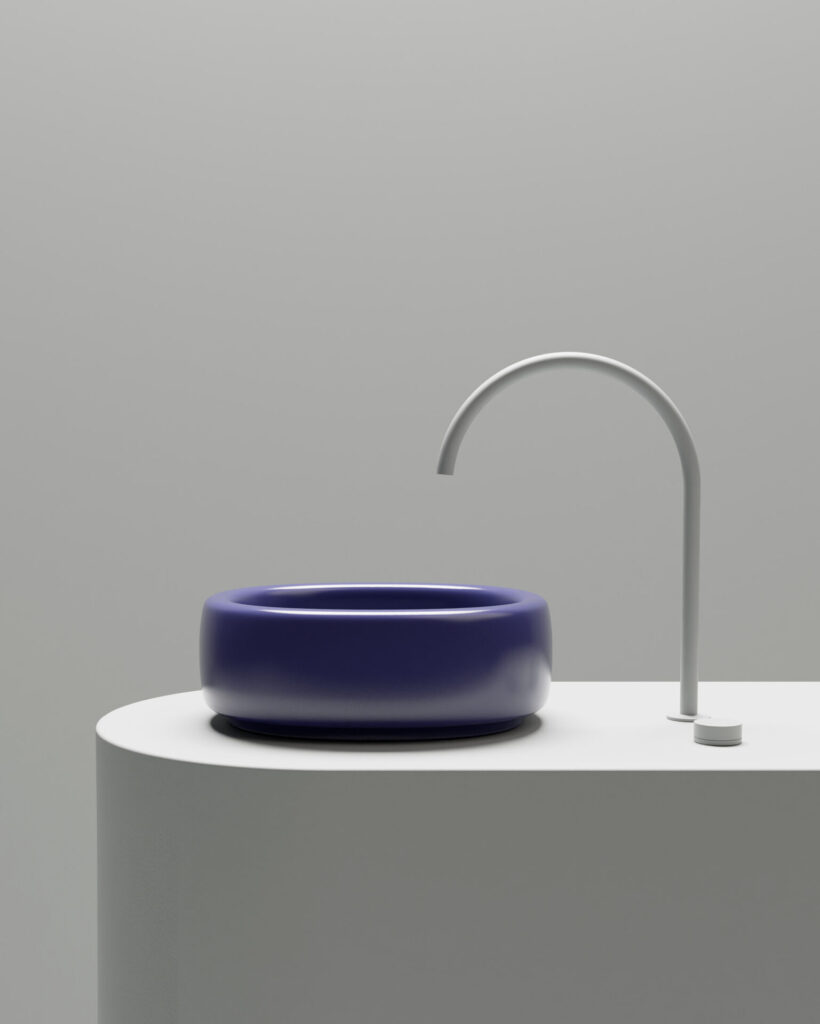 Glossy cobalt blue Bold washbasin by Valdama paired with a minimalist faucet, highlighting the collection's rounded ceramic basin design.