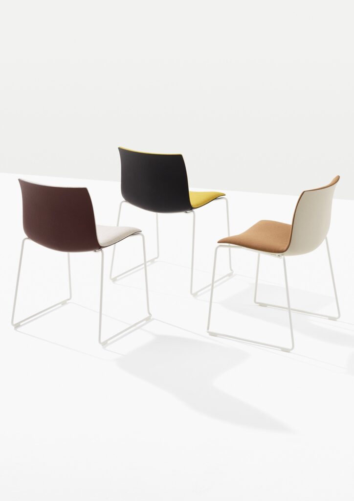 Arper Catifa (RE) 46 recycled seating with sled bases in three two-tone color combinations for hospitality and commercial interiors.