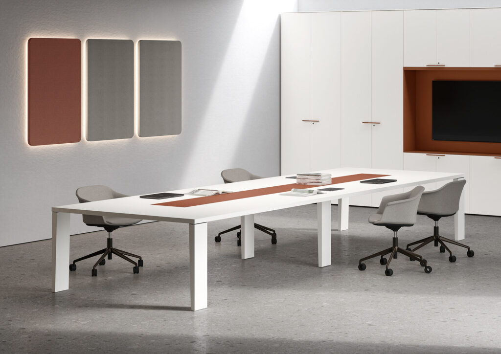Bralco Sile executive office furniture with a white conference table, rust leather center inset, gray conference chairs, and integrated wall storage.