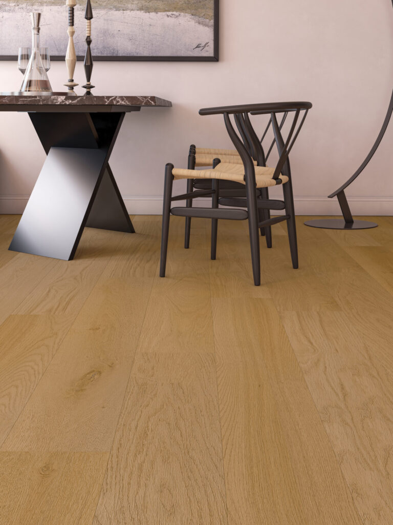 Déco Clap!zer0 wood-effect flooring in Danubio with pale wood-look planks, viewed from above beside a curved sofa and round coffee table in natural light.
