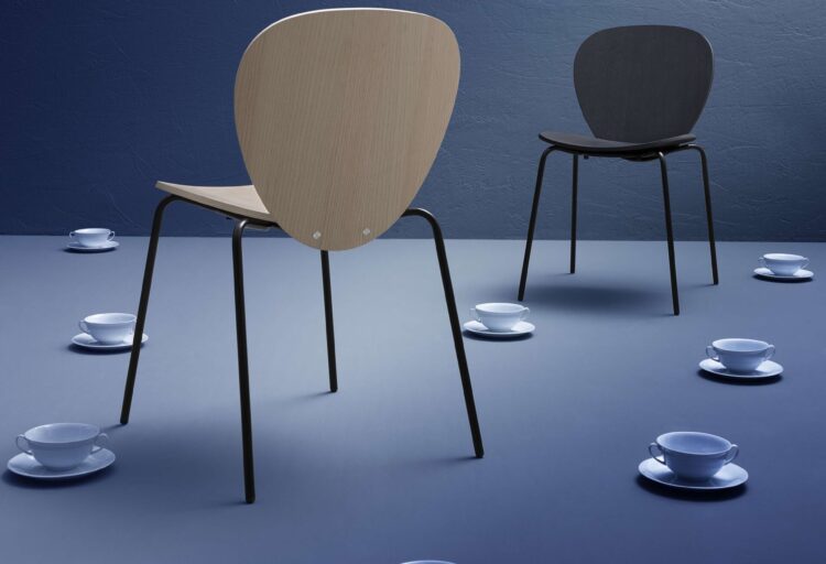 Et al TÊT stackable hospitality seating by Marco Acerbis with natural and black plywood chairs on slender metal frames.