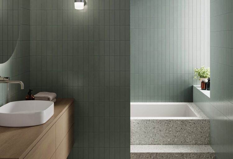 Northern Hall IP65 wall sconce with mouth-blown opal glass illuminating a contemporary bathroom with green tiled walls and terrazzo finishes