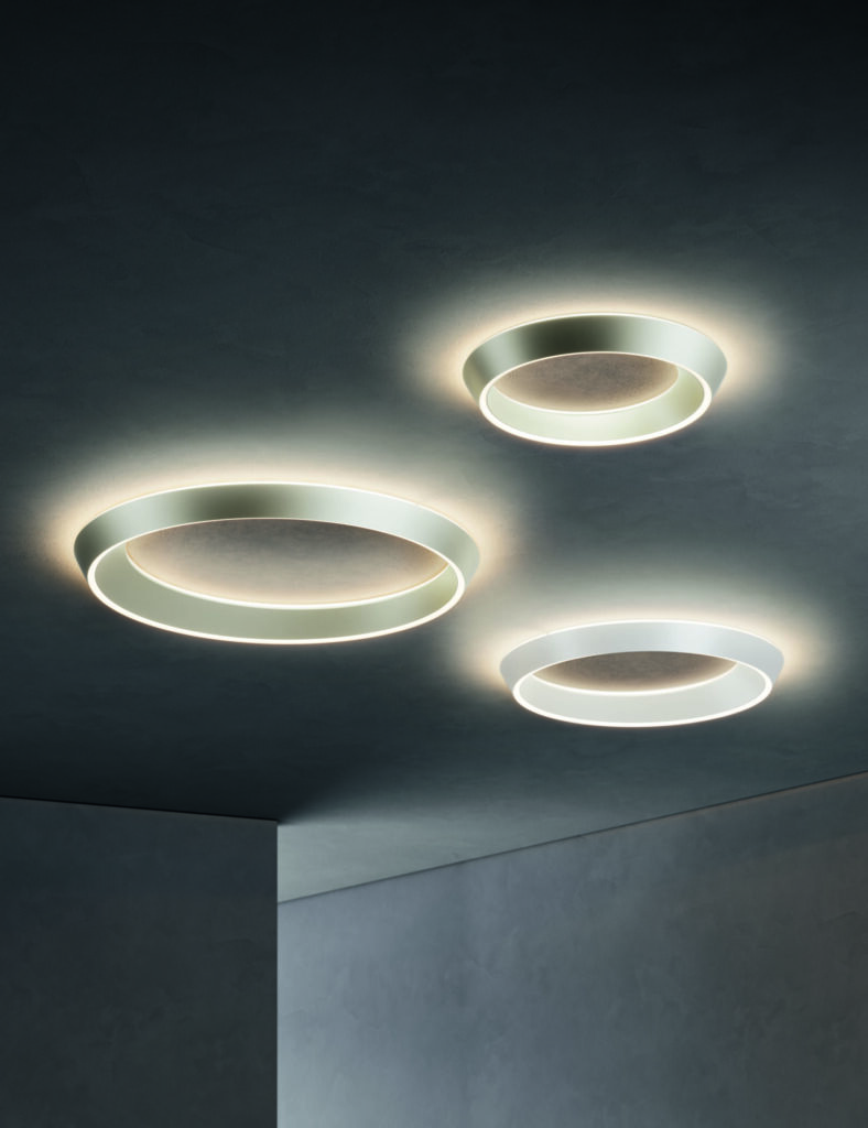 Lodes Tidal modern ceiling lighting in three flush-mounted sizes, showing the collection's asymmetrical ring design and soft halo illumination.