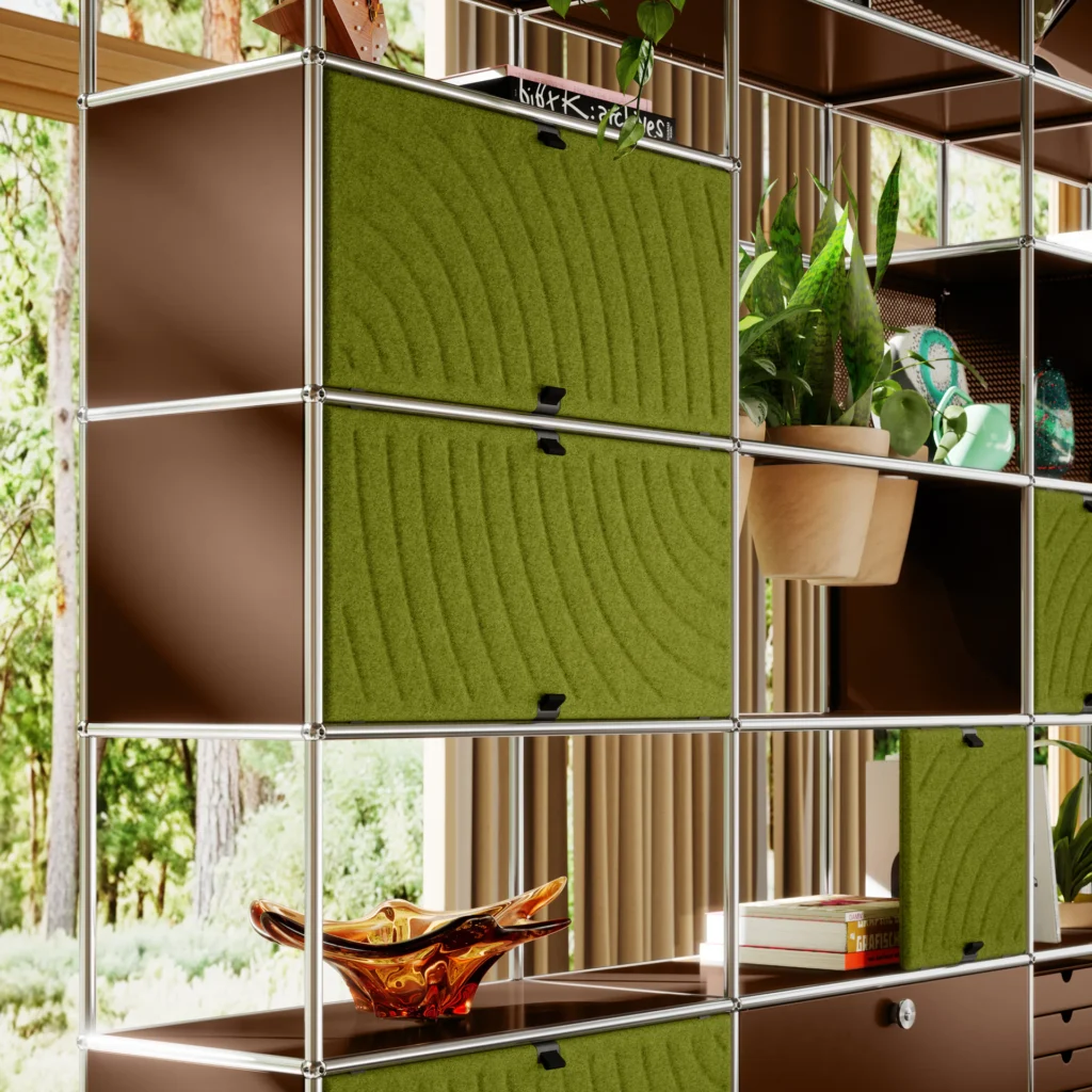 Green USM Haller Soft Panel acoustic panels installed in a chrome modular shelving system with plants and open storage.