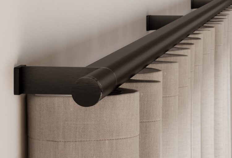 Lutron Palladiom motorized drapery rod in Black Anodized aluminum, shown with a crystal-accented finial and ripple-fold neutral drapery.