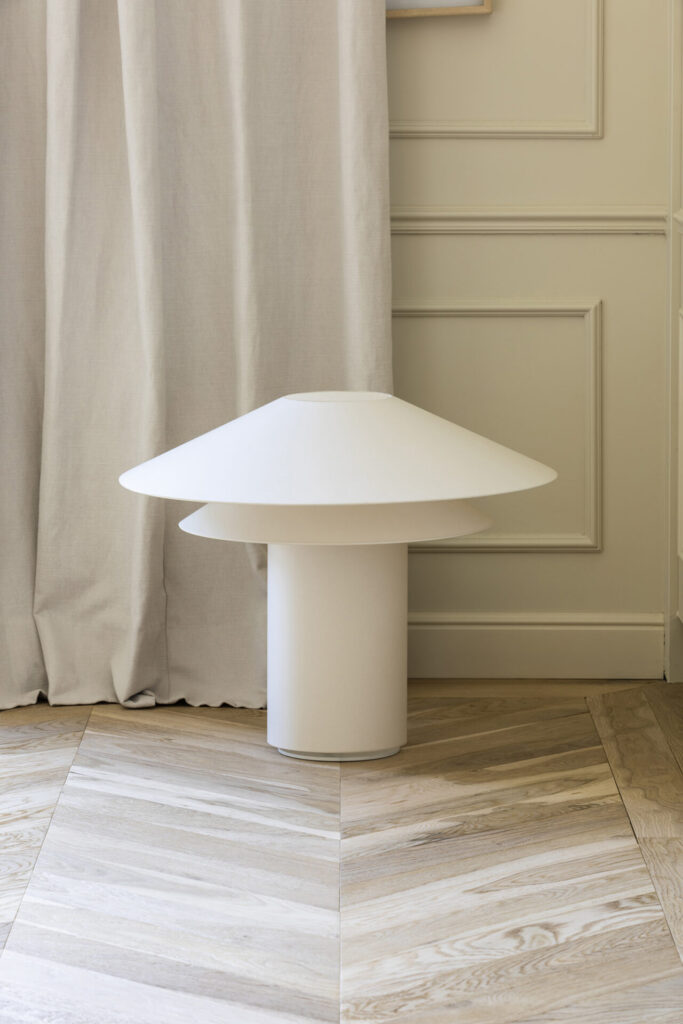 Faro Barcelona Shan parchment table lamp with three layered white shades in a neutral interior