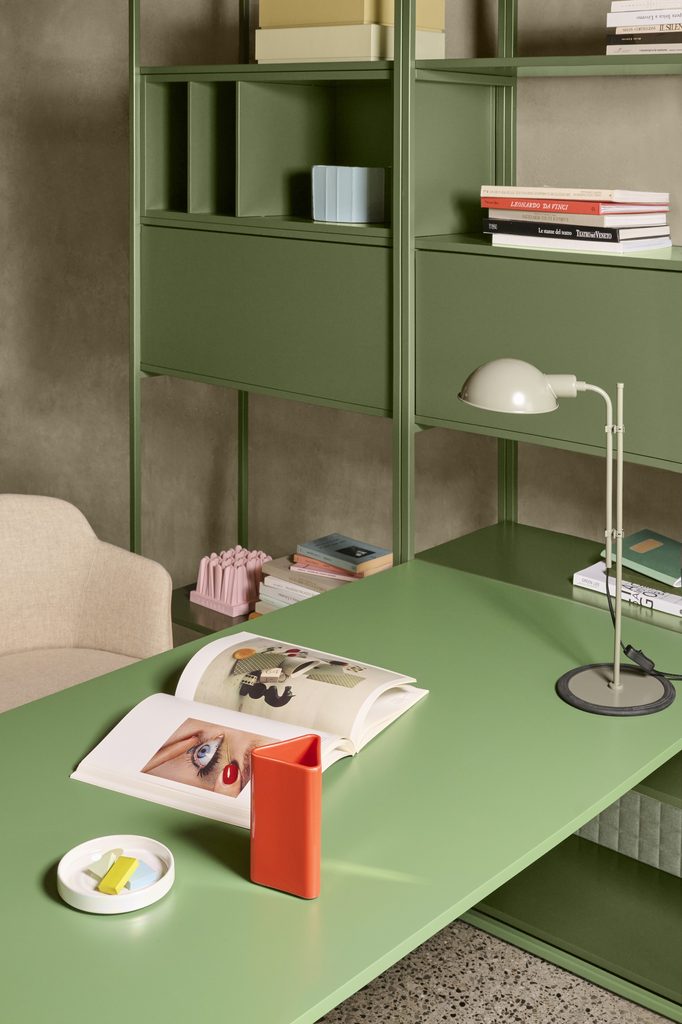 Green Line System Desk with an open book and task lamp, extending from matching metal shelving and cabinets.