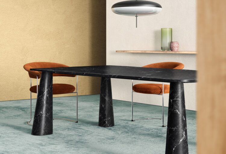 Close view of Hanabira’s Nero Marquina marble top and curved stone legs, showing white veining against black stone.